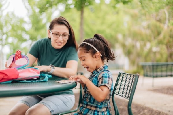 mother-and-daughter-going-through-book-bag-after-f-2024-11-01-02-39-12-utc